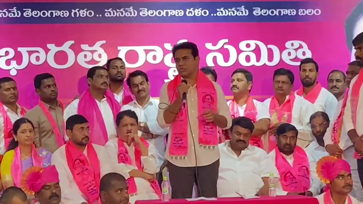 Ravi Yadav welcoming new members into BRS party with pink scarves in Serilingampally.