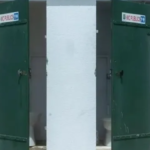 Government official explaining the Swachh Bharat Mission-2 toilet construction subsidy scheme in a Telangana village.